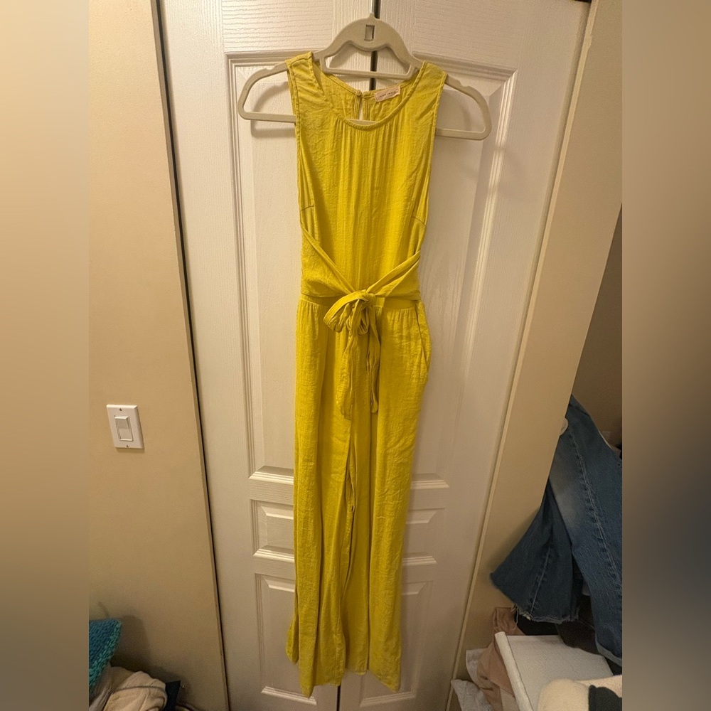 Yellow jumpsuit with a waist tie in size small.